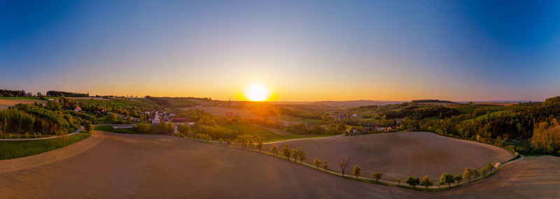 Scenic view of landscape against clear sky during sunset