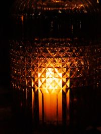 Close-up of illuminated lamp in dark room