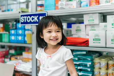 Portrait of smiling girl standing in store