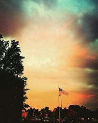 Low angle view of street light against cloudy sky