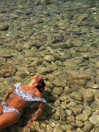 High angle view of woman on rock at beach