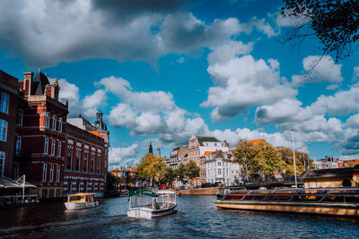 Panoramic view of river amidst buildings against sky