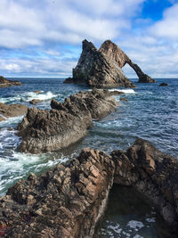 Scenic view of sea against cloudy sky