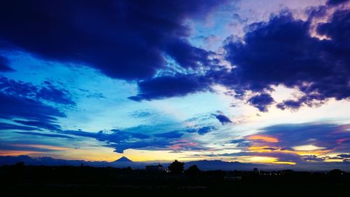 Scenic view of dramatic sky over city