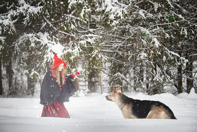 Rear view of woman holding dog