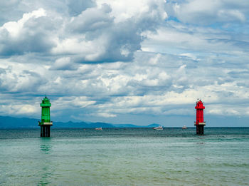 Lighthouse by sea against sky