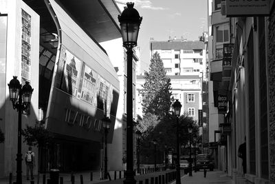 Text on street in city against sky