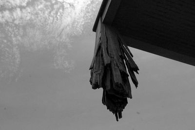Low angle view of clothes hanging on roof against sky