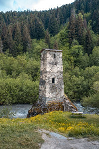 Built structure in forest against sky