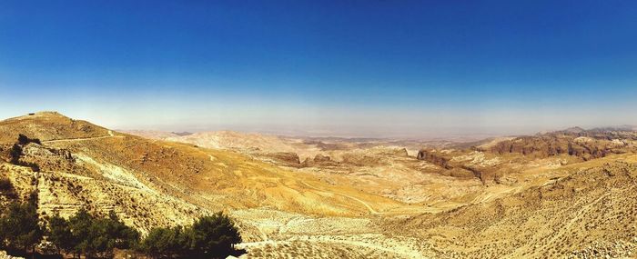 Scenic view of mountains against clear blue sky