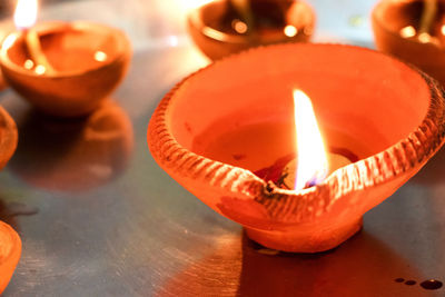 Close-up of lit candles on table