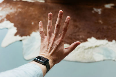 Midsection of person touching finger