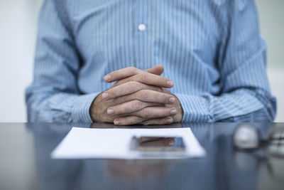 Person sitting at office desk with documents