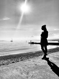 Silhouette man on beach against sky