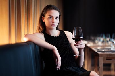 Portrait of young woman holding coffee cup