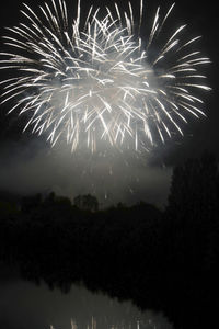 Low angle view of firework display at night