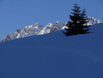 Scenic view of snowcapped mountains against clear blue sky