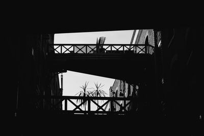 Low angle view of silhouette bridge against sky