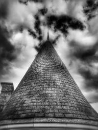 Low angle view of building against cloudy sky