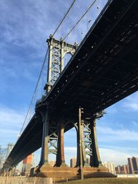 Low angle view of manhattan bridge against sky