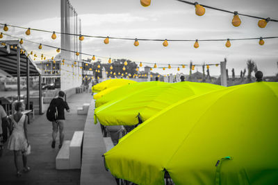 Rear view of people on yellow bridge