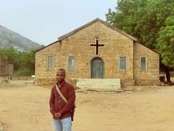 A man in front of a church