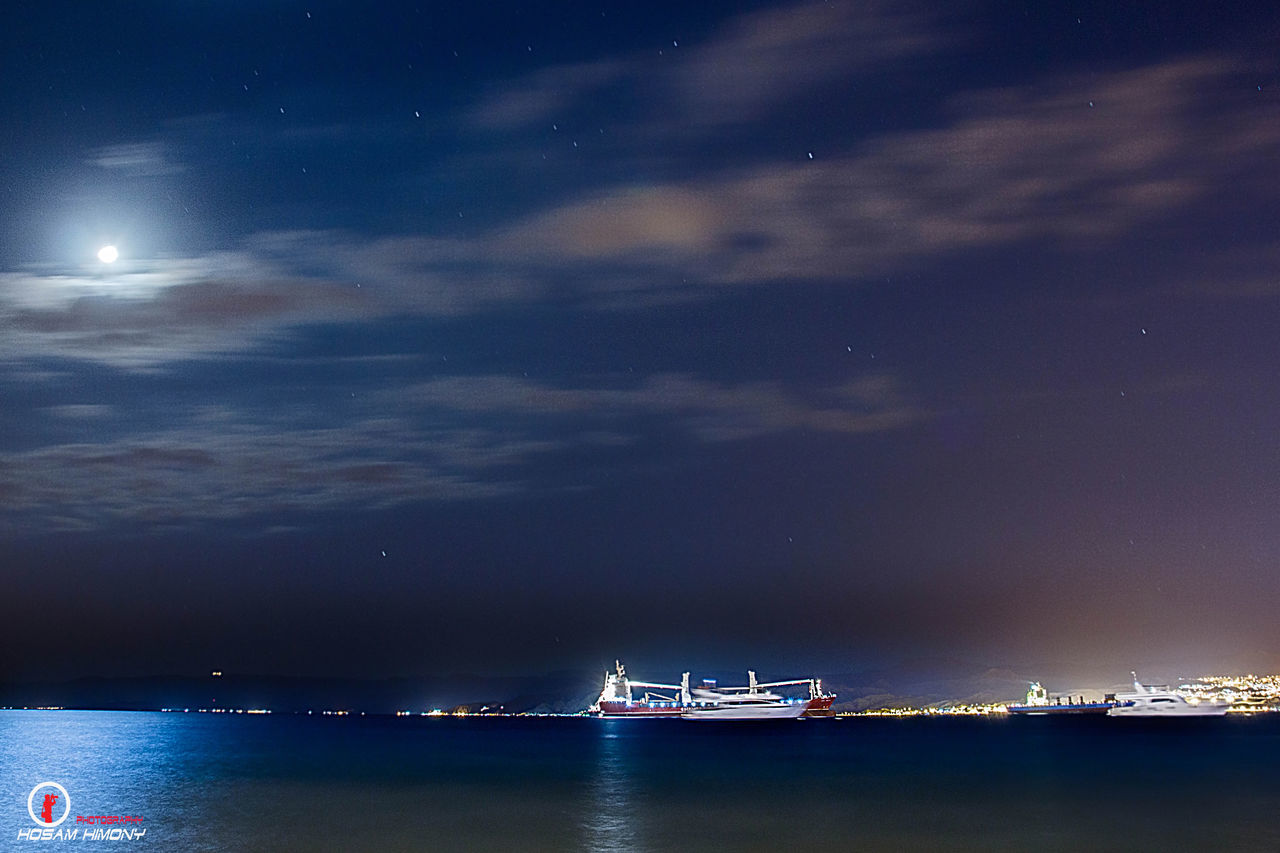 nautical vessel, transportation, water, sea, mode of transport, waterfront, boat, sky, scenics, nature, beauty in nature, tranquility, sailing, cloud - sky, tranquil scene, illuminated, night, ship, travel, blue