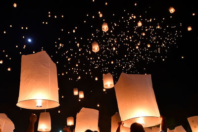 Low angle view of illuminated lanterns at night