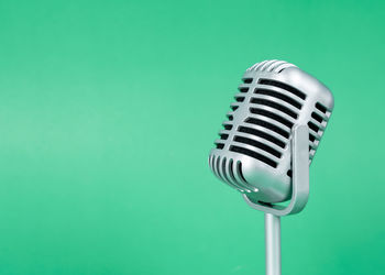 Close-up of electric fan against blue background