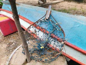 High angle view of fishing net hanging on rope