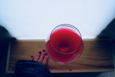 Midsection of person holding red drink
