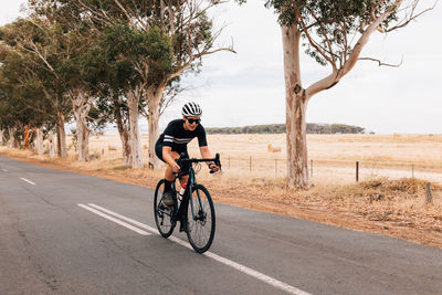 Woman riding bicycle on road