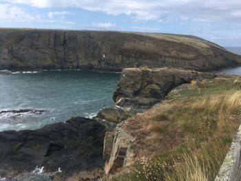 Scenic view of sea and rocks against sky