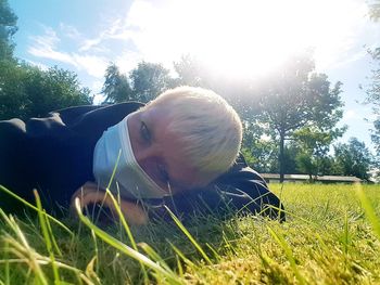 Portrait of man on field against bright sky