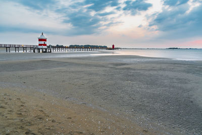 Scenic view of beach against sky during sunset