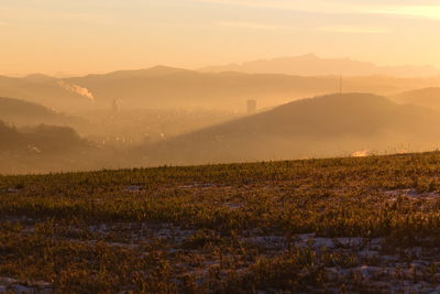 Scenic view of field against sky during sunset