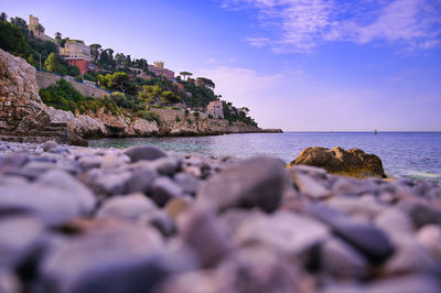 Rocks on beach against sky