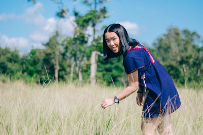 Portrait of woman standing on field