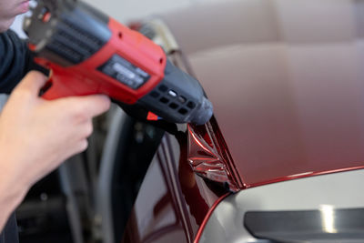 Cropped hand of man repairing car