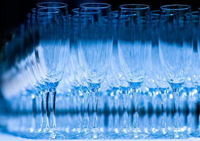 Close-up of champagne flutes arranged on table