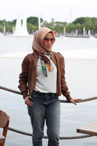 Young woman wearing sunglasses standing outdoors