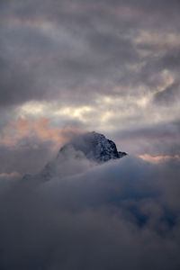 Low angle view of snow covered mountain against sky