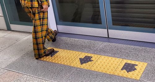 Low section of man standing on footpath