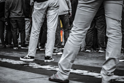 Low section of people standing on street