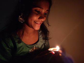 Close-up of woman holding candle