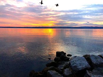 Scenic view of sea against sky at sunset