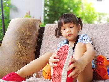 Cute girl playing on sofa