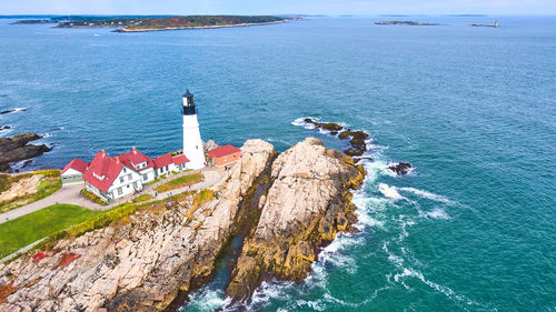 High angle view of lighthouse by sea