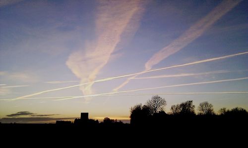 Silhouette of trees against sky at sunset