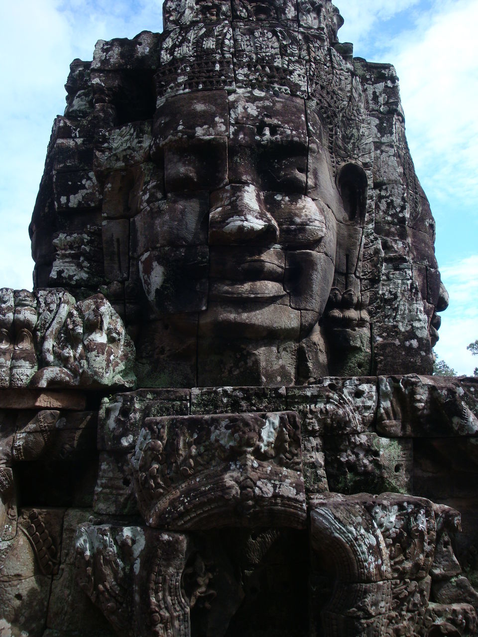 low angle view, sky, history, religion, spirituality, the past, sculpture, old, old ruin, human representation, ancient, statue, architecture, stone material, place of worship, built structure, art and craft, famous place, art